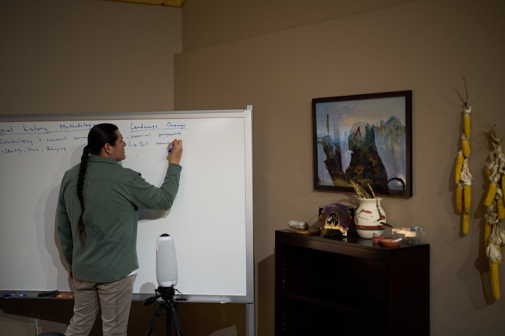 Mike Barthelemy, Native American studies director at Nueta Hidatsa Sahnish College, writes on a whiteboard during a class Thursday, Oct. 30, 2025, in New Town, N.D. (AP Photo/John Locher)