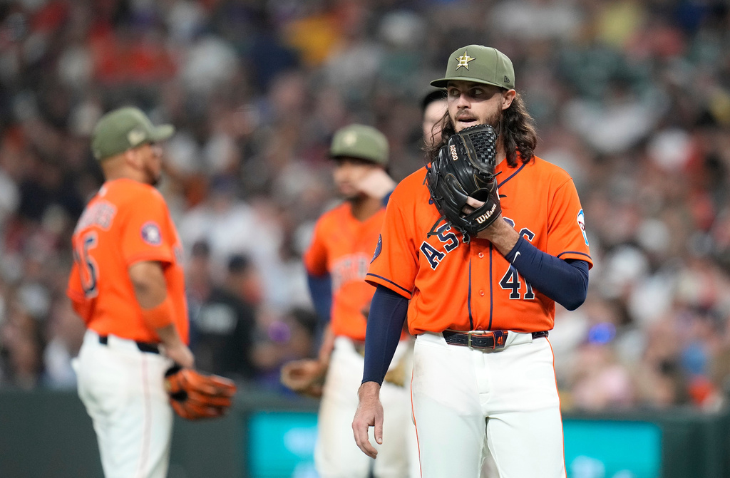 Houston Astros starting pitcher Spencer Arrighetti (41) reacts as he waits for officials to review a play at first base which secured his no-hit bid against the Texas Rangers during the seventh inning of a baseball game, Friday, May 15, 2026, in Houston. (AP Photo/Karen Warren)
