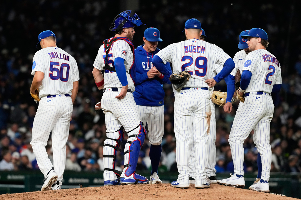 Chicago Cubs manager Craig Counsell, third from left, talks to players after he pulled starting pitcher Jameson Taillon, left, during the seventh inning of a baseball game against the Athletics in Chicago, Tuesday, June 2, 2026. (AP Photo/Nam Y. Huh)
