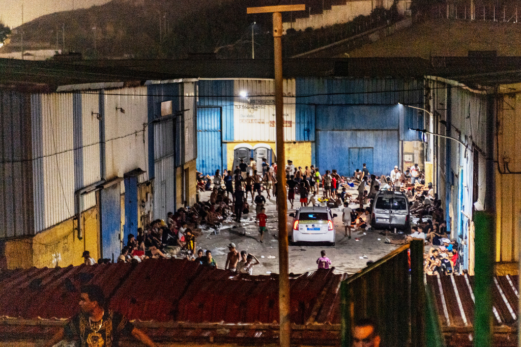 Migrants spend the night on the streets after crossing from Morocco into the Spanish enclave of Ceuta, Friday, July 31, 2026. (AP Photo/Antonio Sempere)