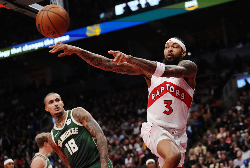 Toronto Raptors' Brandon Ingram (3) passes as Milwaukee Bucks' Kyle Kuzma (18) looks on during first half NBA basketball action in Toronto on Tuesday, Nov. 4, 2025. (Nathan Denette/The Canadian Press via AP)
