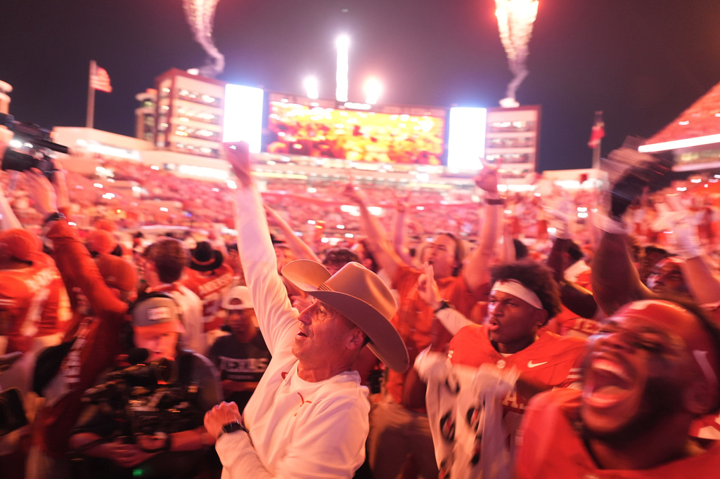 Texas head coach Steve Sarkisian, center and Texas players celebrate their win over Ohio State in an NCAA college football game in Austin, Texas, Saturday, Sept. 12, 2026. (AP Photo/Eric Gay)