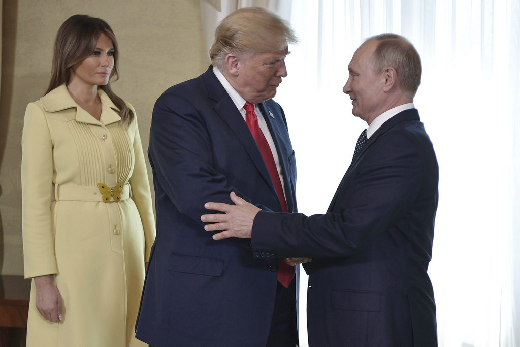 FILE - First lady Melania Trump, left, watches as President Donald Trump and Russian President Vladimir Putin welcome each other at the Presidential Palace in Helsinki, Finland, July 16, 2018, prior to Trump's and Putin's one-on-one meeting. (Alexei Nikolsky, Sputnik, Kremlin Pool Photo via AP)
