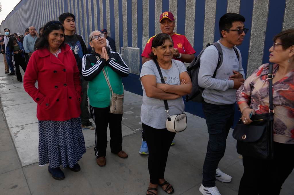 Voters wait for the opening of a polling station during general elections in Lima, Peru, Sunday, April 12, 2026. (AP Photo/Martin Mejia)
