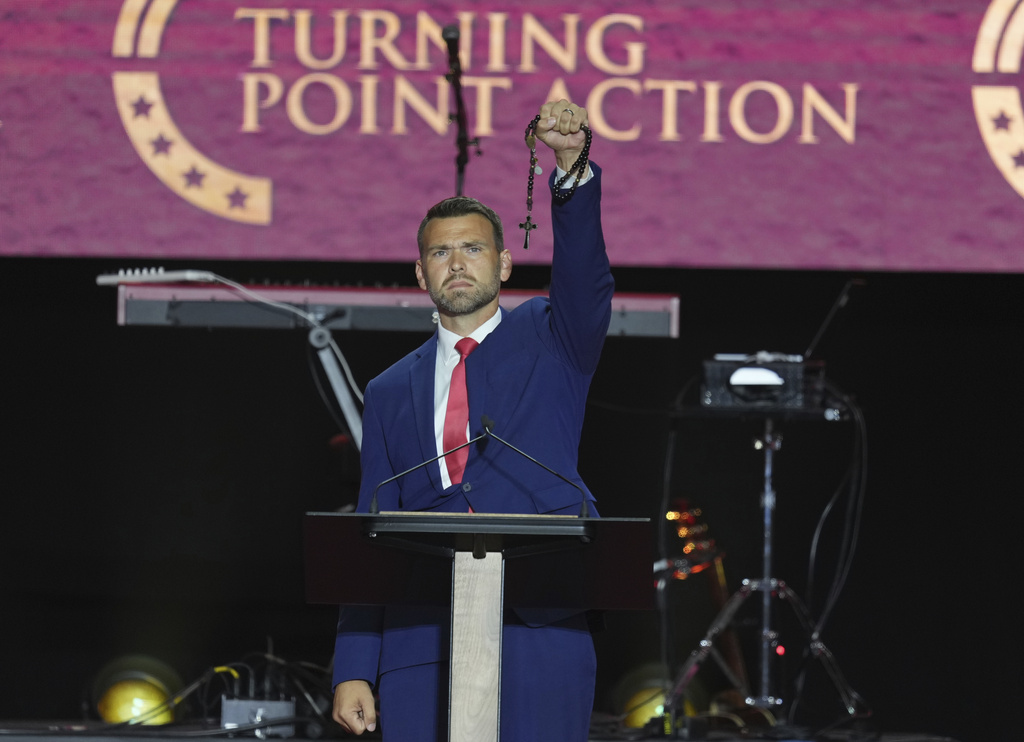 Jack Posobiec speaks at a memorial for Charlie Kirk, Sunday, Sept. 21, 2025, at State Farm Stadium in Glendale, Ariz. (AP Photo/Ross D. Franklin)