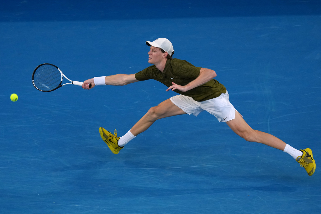 Jannik Sinner of Italy plays a forehand return to his compatriot Luciano Darderi during their fourth round match at the Australian Open tennis championship in Melbourne, Australia, Monday, Jan. 26, 2026. (AP Photo/Aaron Favila)