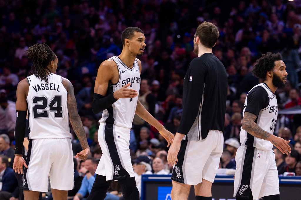 San Antonio Spurs' Victor Wembanyama, center left, celebrates with teammates during the first half of an NBA basketball game against the Philadelphia 76ers, Tuesday, March 3, 2026, in Philadelphia. (AP Photo/Chris Szagola)