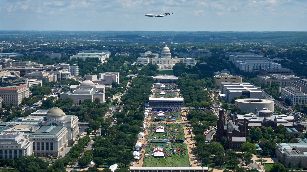 Air Force One flies over the U.S. Capitol before the IndyCar Freedom 250 Grand Prix auto race in Washington, Sunday, Aug. 23, 2026, as seen from the Washington Monument. (AP Photo/Manuel Balce Ceneta)