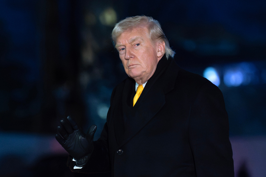 President Donald Trump waves to the media as he walks on the South Lawn upon his arrival to the White House, Monday, Feb. 9, 2026, in Washington. (AP Photo/Jose Luis Magana)