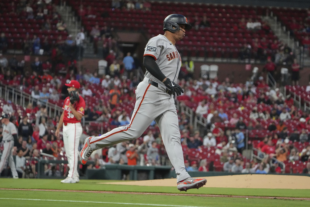 San Francisco Giants' Rafael Devers, right, rounds the bases after hitting a solo home run off St. Louis Cardinals starting pitcher Michael McGreevy, left, during the first inning of a baseball game Friday, Sept. 5, 2025, in St. Louis. (AP Photo/Jeff Roberson)