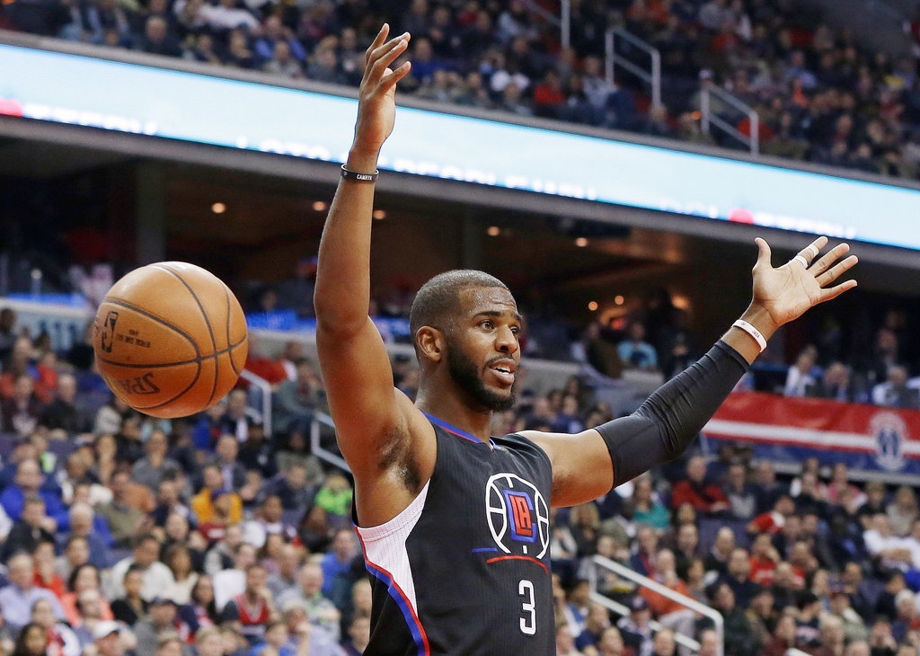 FILE - Los Angeles Clippers guard Chris Paul reacts after dunking the ball during the first half of an NBA basketball game against the Washington Wizards, Monday, Dec. 28, 2015, in Washington. (AP Photo/Carolyn Kaster, File)