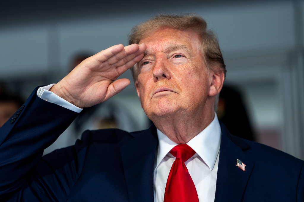 President Donald Trump is pictured during the playing of the national anthem at the IndyCar Freedom 250 Grand Prix auto race, Sunday, Aug. 23, 2026, in Washington. (Doug Mills/The New York Times via AP, Pool)