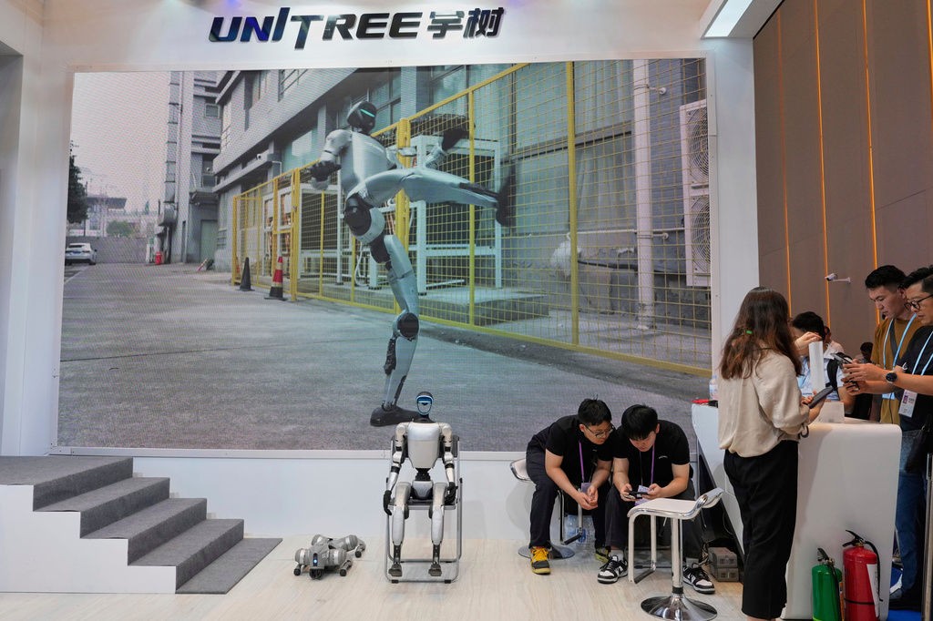 FILE - A humanoid and four legged robot from Unitree waits to demonstrate at the 137th Canton Fair in Guangzhou in southern China's Guangdong province on April 16, 2025. (AP Photo/Ng Han Guan, File)