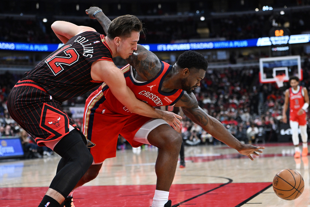 New Orleans Pelicans' Zion Williamson, right, battles Chicago Bulls' Zach Collins (12) for the ball during the first half of an NBA basketball game Sunday, Dec. 14, 2025, in Chicago. (AP Photo/Paul Beaty)