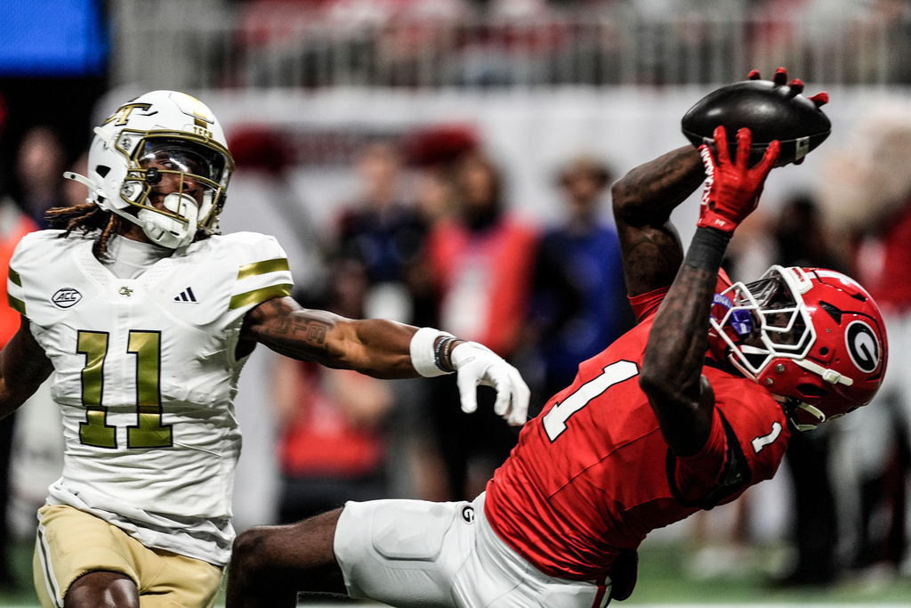 Georgia defensive back Ellis Robinson IV (1) intercepts the ball from Georgia Tech wide receiver Dean Patterson (11) during the second half of an NCAA college football game, Friday, Nov. 28, 2025, in Atlanta. (AP Photo/Mike Stewart)