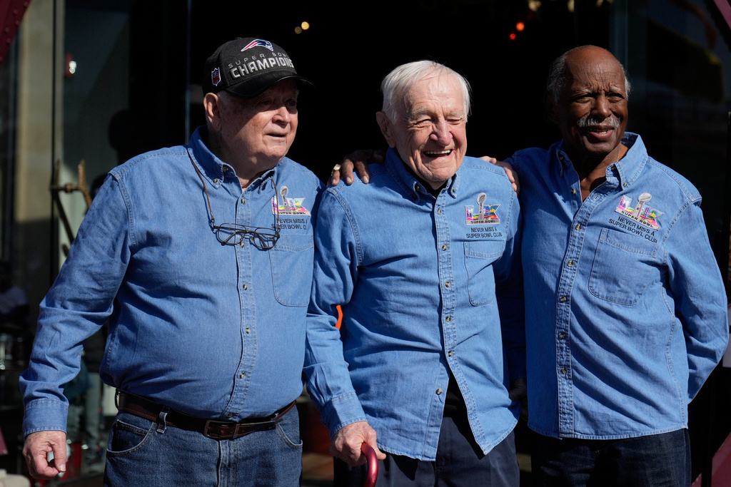 Don Crisman, Tom Henschel and Gregory Eaton, from left, friends who have attended every Super Bowl football game, pose for photos before a news conference at Hard Rock Cafe in San Francisco, Friday, Feb. 6, 2026. (AP Photo/Jeff Chiu)
