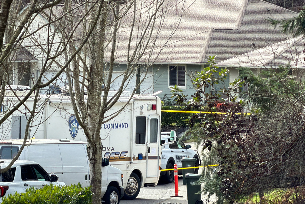 Authorities investigate the scene after reports that a person fatally stabbed multiple people on Tuesday, Feb. 24, 2026, in Gig Harbor, Wash. (AP Photo/John Froschauer)