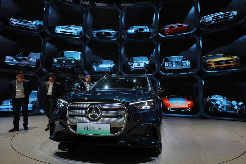 Visitors look at a Mercedes latest GLC SUV model showcased at the Auto China 2026, in Beijing, Saturday, April 25, 2026. (AP Photo/Andy Wong)