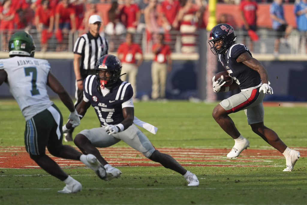 Mississippi running back Kewan Lacy (5) follows a block by wide receiver Winston Watkins (17) on Tulane safety Kevin Adams III (7) during the second half of an NCAA college football game in Oxford, Miss., Saturday, Sept. 20, 2025. (AP Photo/Rogelio V. Solis)
