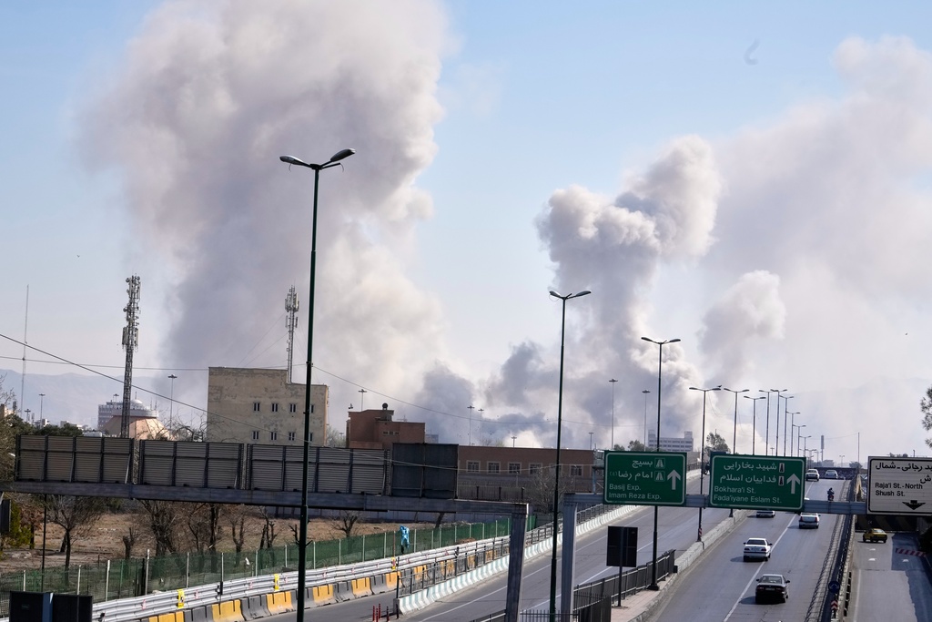 Plumes of smoke rise as strikes hit the city during the U.S.–Israeli military campaign in Tehran, Iran, Thursday, March 5, 2026. (AP Photo/Vahid Salemi)