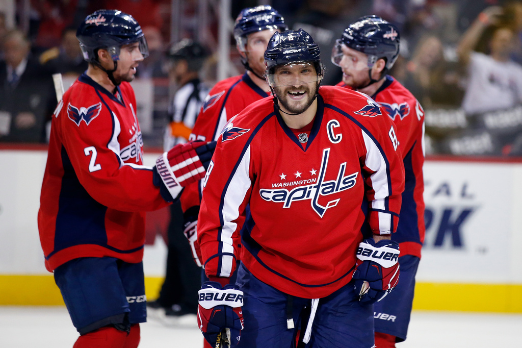 FILE - Washington Capitals left wing Alex Ovechkin (8), from Russia, smiles after a goal by defenseman Karl Alzner in the third period of an NHL hockey game against the Boston Bruins, Thursday, Nov. 5, 2015, in Washington. (AP Photo/Alex Brandon, File)