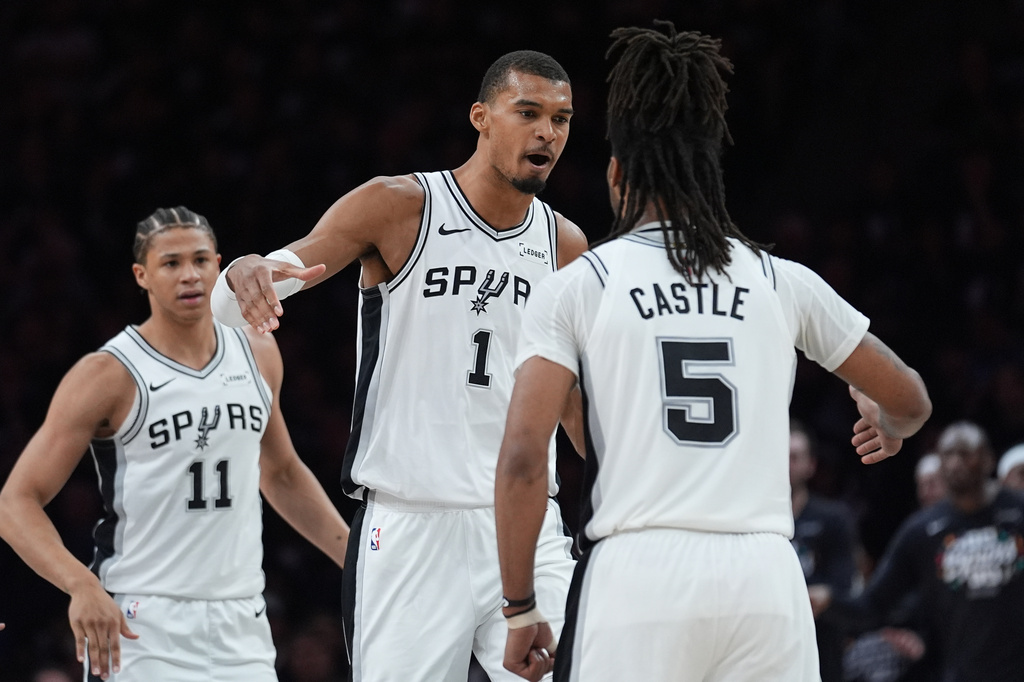San Antonio Spurs forward Victor Wembanyama (1) celebrates a score with guard Stephon Castle (5) during the first half of Game 6 of an NBA basketball second-round playoffs series in Minneapolis, Friday, May 15, 2026. (AP Photo/Abbie Parr)