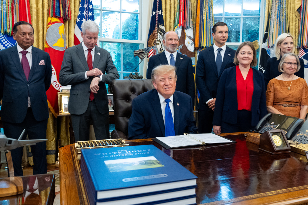 President Donald Trump winks as the members of the media depart the Oval Office of the White House as Essar Capital Director Prashant Ruia, from left, Energy Secretary Chris Wright, Commerce Secretary Howard Lutnick, John Jovanovic, chairman of the Export-Import Bank of the United States, Iowa Attorney General Brenna Bird, Mariannette Miller-Meeks, R-Iowa., and Rep. Ashley Hinson, R-Iowa, look on, Monday, Sept. 28, 2026, in Washington. (AP Photo/Alex Brandon)