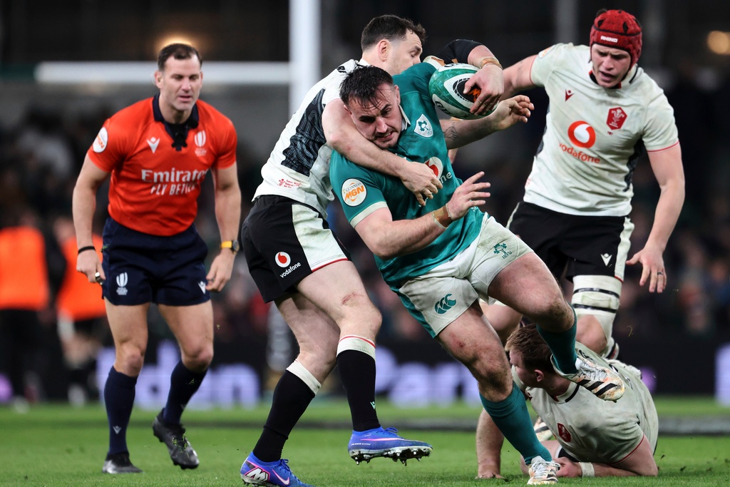 Ireland's Rónan Kelleher, center, is tackled by Wales' players during a Six Nations rugby union match between Ireland and Wales in Dublin, Ireland, Friday, March 6, 2026. (AP Photo/Peter Morrison)