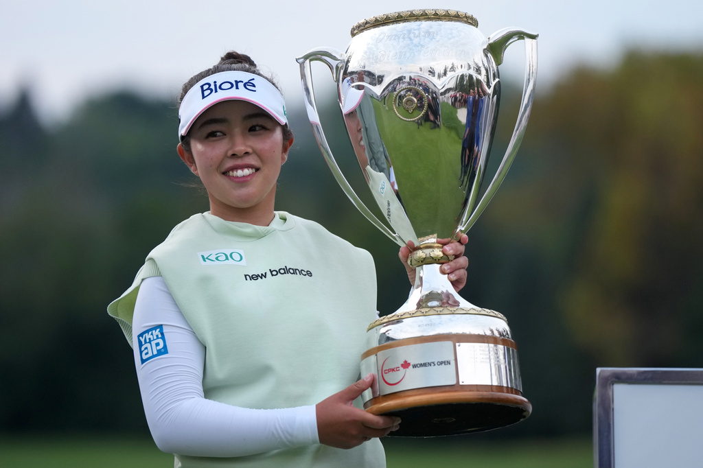 Miyu Yamashita, of Japan, celebrates with the trophy after winning the LPGA Canadian Women's Open golf tournament in Edmonton, Alberta, Sunday, Aug. 23, 2026. (Darryl Dyck/The Canadian Press via AP)