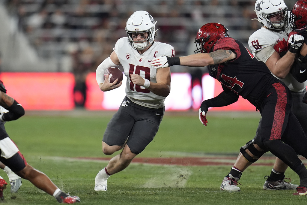 FILE - Washington State quarterback John Mateer runs with the ball during the first half of an NCAA college football game against San Diego State, Oct. 26, 2024, in San Diego. (AP Photo/Gregory Bull, File)