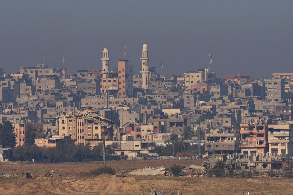 Destroyed buildings in the Gaza Strip are seen from southern Israel, Tuesday, Nov. 18, 2025. (AP Photo/Ohad Zwigenberg)