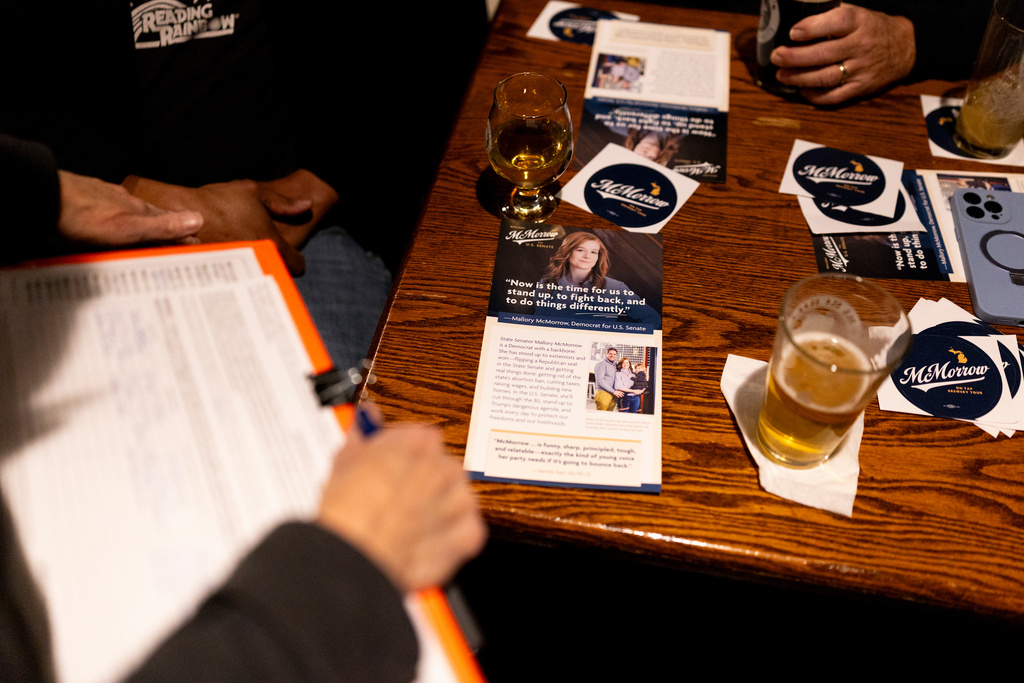 Promotional materials on a table during a campaign event for Michigan State Sen. Mallory McMorrow, a candidate for the U.S. Senate, on Thursday, Feb. 5, 2026, at Churchill's Food & Spirits in Flint, Mich. (AP Photo/Emily Elconin)