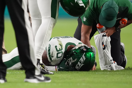 New York Jets cornerback Michael Carter II (30) is assisted by team staff after suffering an unknown injury in the first half of an NFL football game against the Miami Dolphins, Monday, Sept. 29, 2025, in Miami Gardens, Fla. (AP Photo/Rebecca Blackwell) New York Jets cornerback Michael Carter II (30) is assisted by team staff after suffering an unknown injury in the first half of an NFL football game against the Miami Dolphins, Monday, Sept. 29, 2025, in Miami Gardens, Fla. (AP Photo/Rebecca Blackwell)
