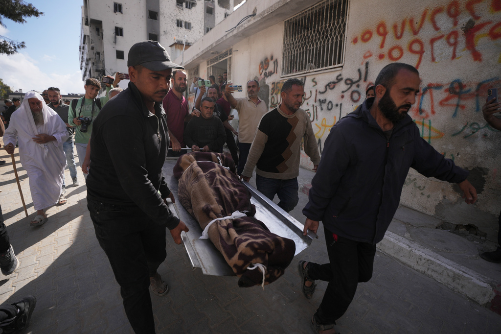 Palestinians carry the body of a person killed in Israeli airstrikes Friday targeting Izz al-Din al-Haddad, the leader of Hamas’ Qassam Brigades, during a funeral outside Shifa Hospital in Gaza City, Saturday, May 16, 2026. (AP Photo/Jehad Alshrafi)