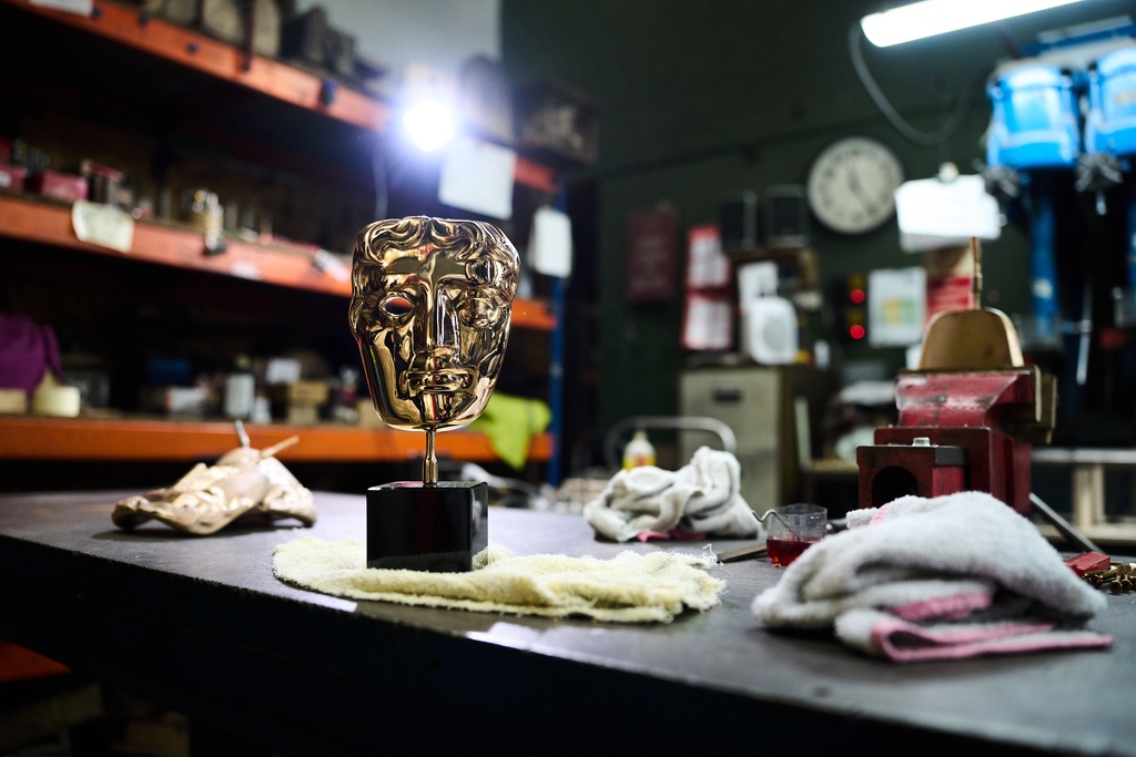 A completed British Academy Film Awards mask sits on a workbench at the FSE Foundry in Braintree, England on Tuesday, Feb. 10, 2026. (Scott A Garfitt/Invision/AP)