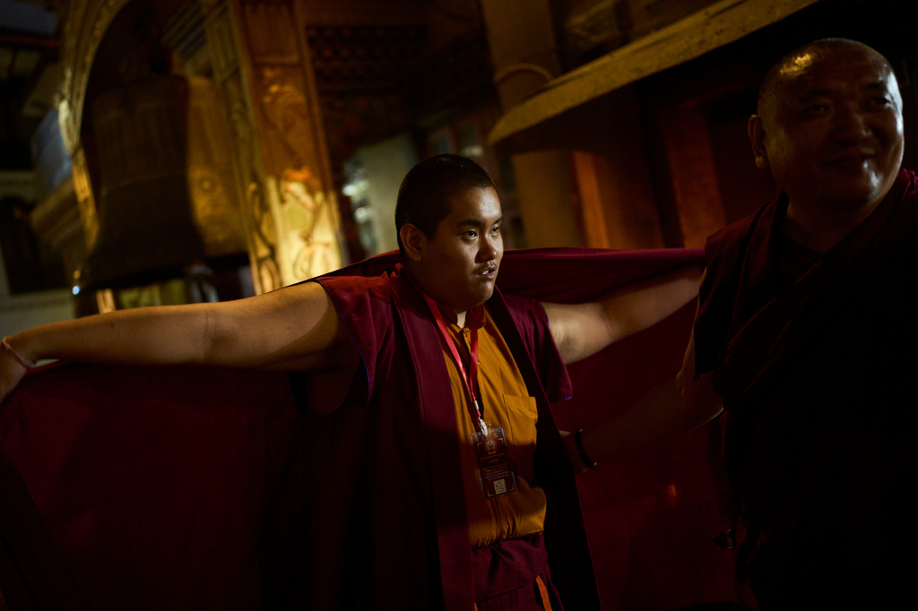 Jalue Dorje fixes his monastic robes while he circumambulates the World Heritage site Boudhanath Stupa in Kathmandu, Nepal, Monday, April 6, 2026. (AP Photo/Niranjan Shrestha)