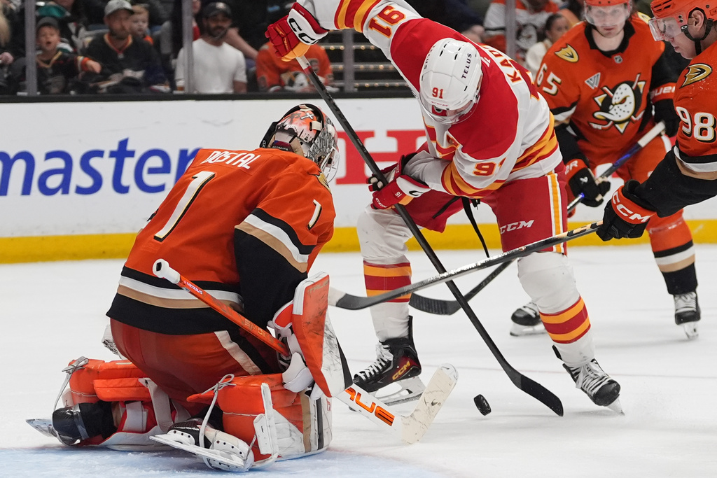 Calgary Flames center Nazem Kadri tries to shoot as Anaheim Ducks goaltender Lukas Dostal (1) defends during the second period of an NHL hockey game Sunday, March 1, 2026, in Anaheim, Calif. (AP Photo/Gregory Bull)