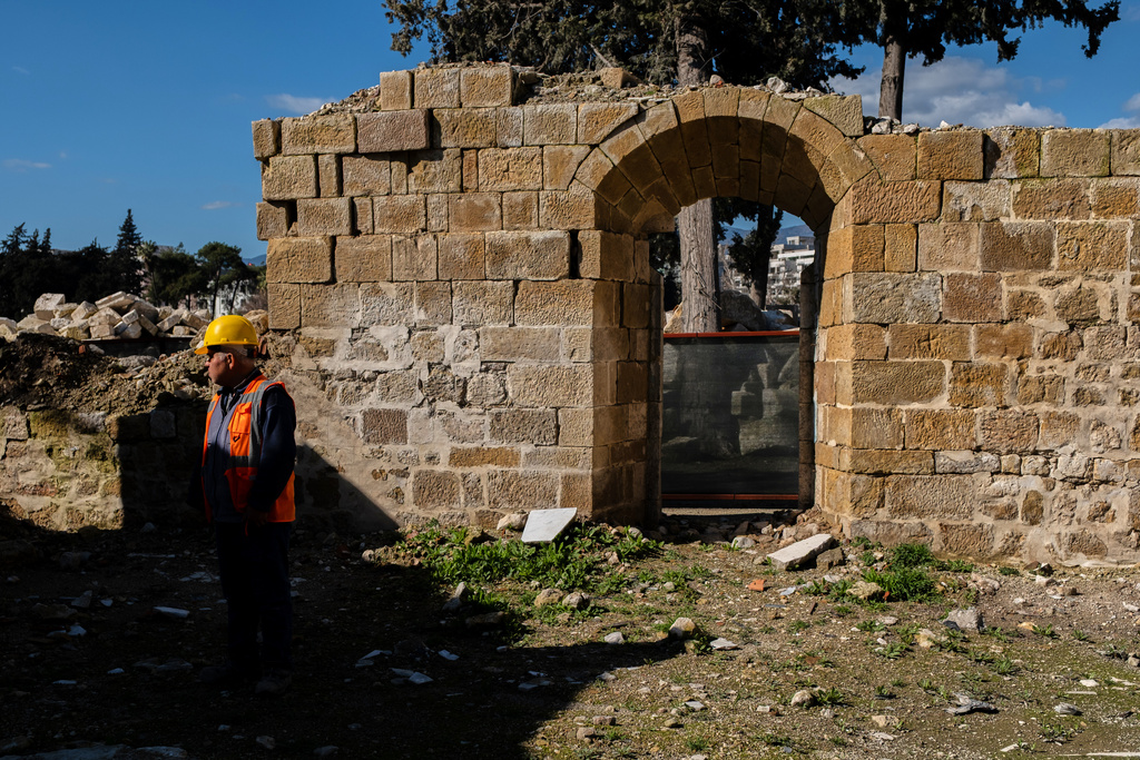 A construction worker stands next to the ruins of St. Paul's Greek Orthodox Church, damaged in the 2023 earthquake, in the city of Antakya, southern Turkey, Wednesday, Feb. 4, 2026. (AP Photo/Murat Kocabas)