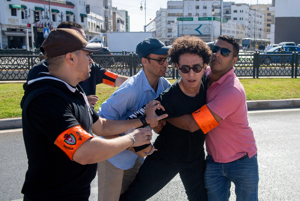 Security forces disperse and arrest protesters during a demonstration demanding healthcare and education reforms, in Rabat, Sunday, Sept. 28, 2025. (AP Photo)