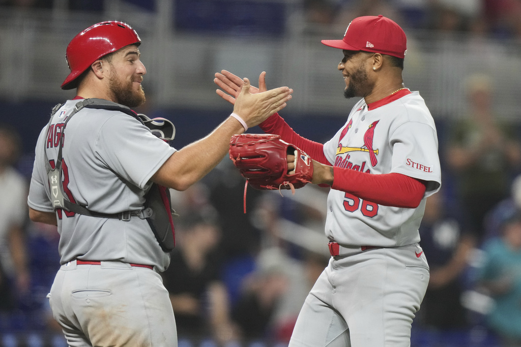 St. Louis Cardinals catcher Pedro Pages, left, shakes hands with relief pitcher Jorge Alcala, right, after defeating the Miami Marlins in a baseball game, Monday, Aug. 18, 2025, in Miami. (AP Photo/Lynne Sladky)