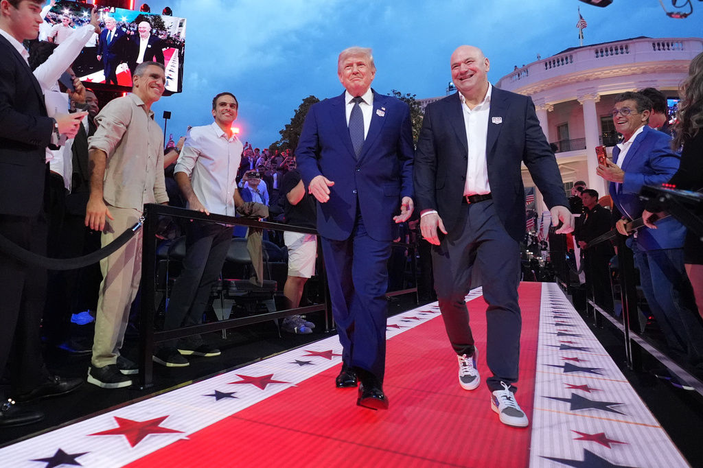 President Donald Trump and Dana White, UFC president and CEO, arrive for UFC Freedom 250 on the South Lawn of the White House, Sunday, June 14, 2026, in Washington. (AP Photo/Alex Brandon)