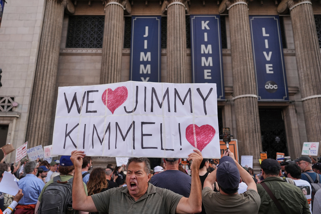 FILE - Oscar Villanueva holds a sign outside El Capitan Entertainment Centre, where the late-night show "Jimmy Kimmel Live!" is staged, Sept. 18, 2025, in Los Angeles. (AP Photo/Jae C. Hong, File)