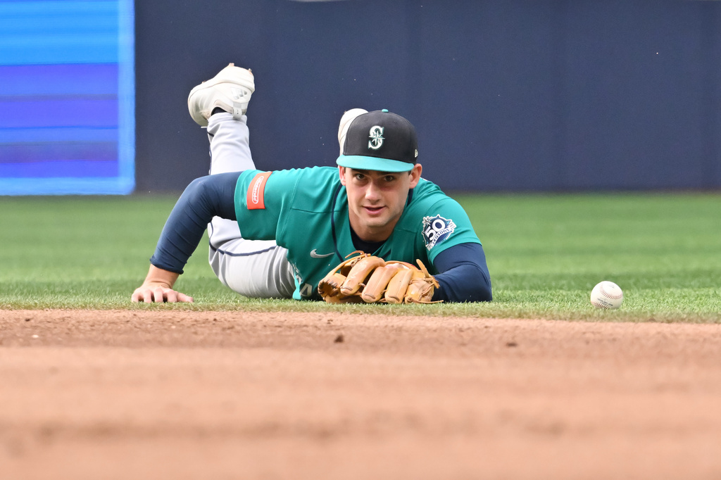 Seattle Mariners second baseman Cole Young is unable to field a ground ball single hit by Toronto Blue Jays' Myles Straw during the fifth inning of a baseball game in Toronto, Saturday, Aug. 29, 2026. (Jon Blacker/The Canadian Press via AP)