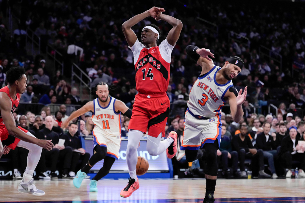 Toronto Raptors guard Ja'Kobe Walter (14) fails to drive past New York Knicks guard Josh Hart (3) during the first half of an NBA basketball game Sunday, Nov. 30, 2025, in New York. (AP Photo/Yuki Iwamura)