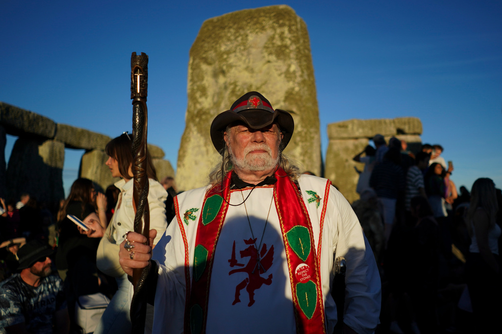 A reveler at the ancient stone circle Stonehenge to celebrate the summer solstice, the longest day of the year, near Salisbury, England, on Saturday, June 20, 2026. (AP Photo/Alberto Pezzali)