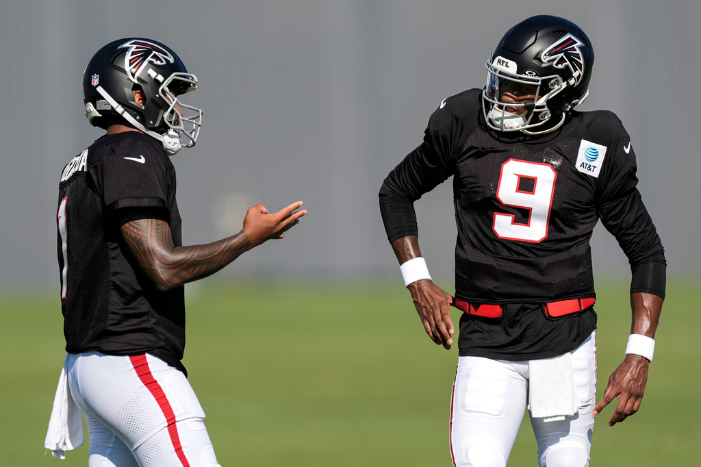 Atlanta Falcons quarterback Michael Penix Jr. (9) and Tua Tagovailoa speak during a Atlanta Falcons training camp, Monday, Aug. 3, 2026, in Flowery Branch, Ga. (AP Photo/Mike Stewart)