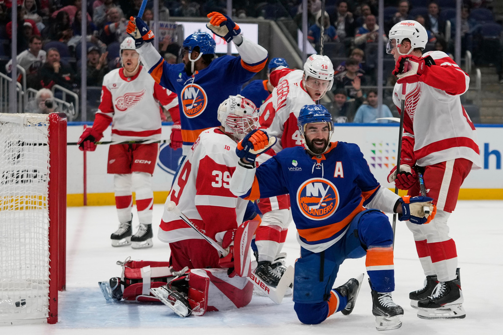 New York Islanders center Kyle Palmieri (21) celebrates after scoring a goal during the second period of an NHL hockey game as Detroit Red Wings goaltender Cam Talbot (39) looks away Thursday, Oct. 23, 2025, at UBS Arena in Elmont, N.Y. (AP Photo/Frank Franklin II)