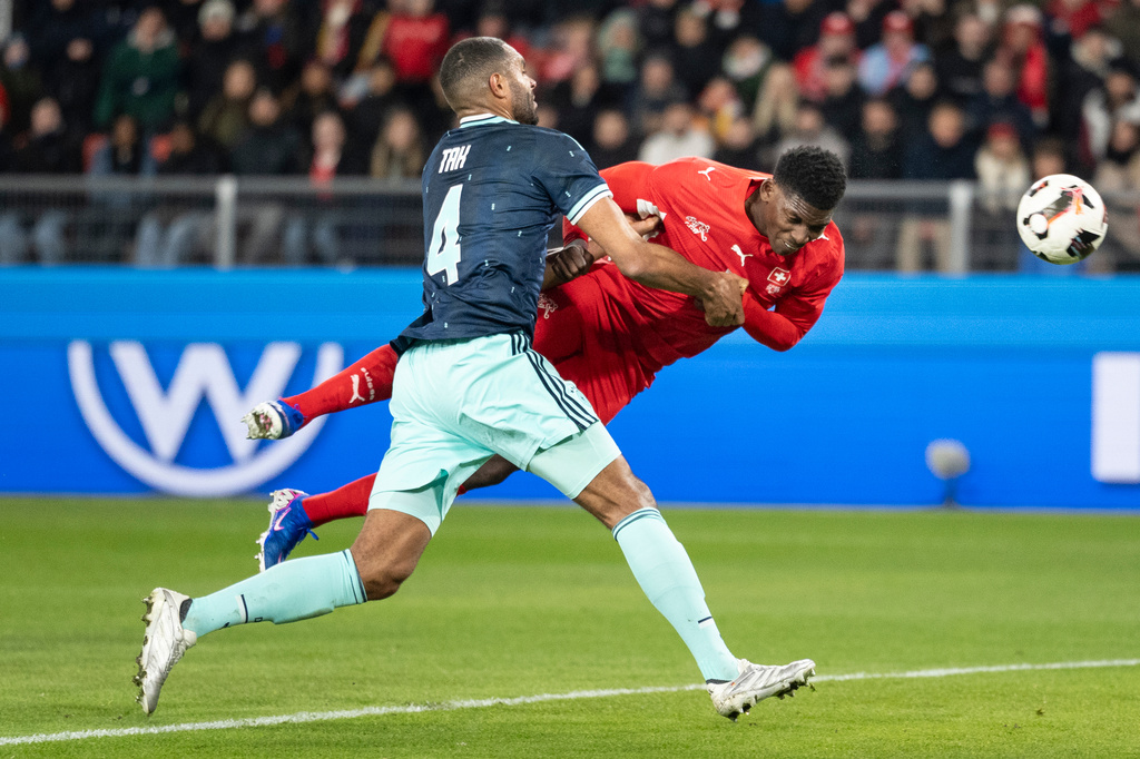 Switzerland's Breel Embolo, right, scores the second goal for Switzerland against Germany's Jonathan Tah, left, during an international friendly soccer match between Switzerland and Germany in Basel, Switzerland, Friday, March 27, 2026. (Claudio Thoma/Keystone via AP)