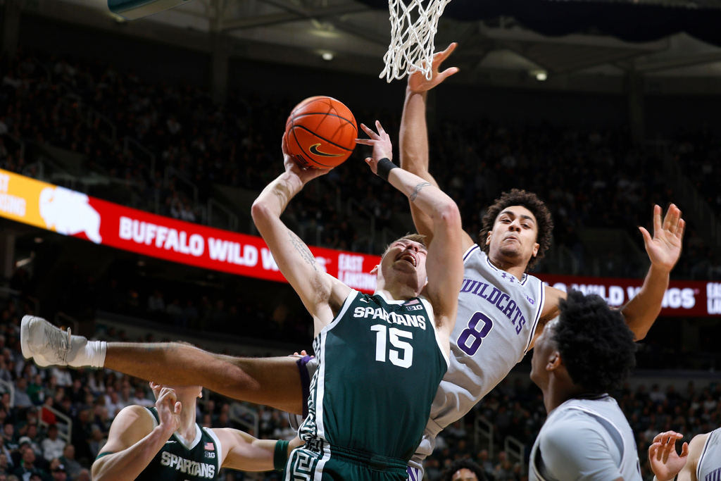 Michigan State center Carson Cooper (15) looks to shoot against Northwestern forward Tre Singleton (8) during the second half of an NCAA college basketball game, Thursday, Jan. 8, 2026, in East Lansing, Mich. (AP Photo/Al Goldis)
