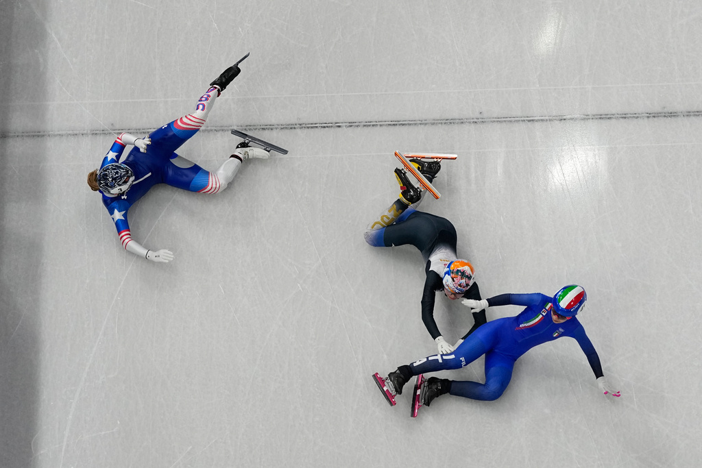 Italy's Arianna Sighel, right, United States' Corinne Stoddard, left, and Japan's Rika Kanai fall as they compete during the women's 500 meters short track speed skating heats race at the 2026 Winter Olympics, in Milan, Italy, Tuesday, Feb. 10, 2026. (AP Photo/Christophe Ena)